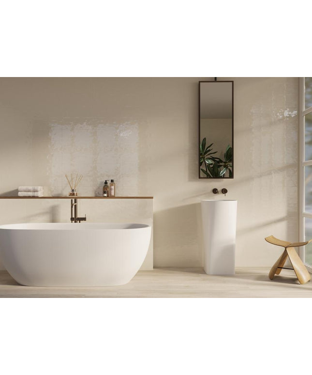 Modern bathroom with a freestanding bathtub, sink, and decorative elements.