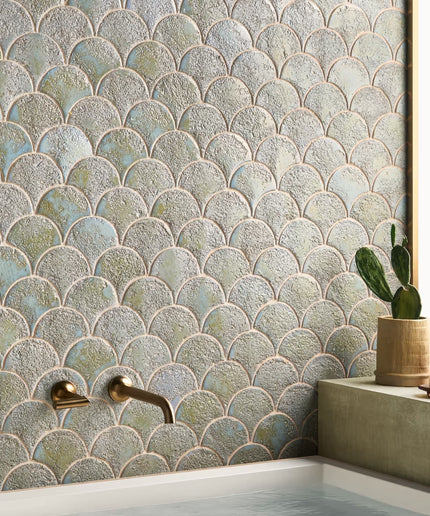 Bathroom with fish-scale patterned tiles, a sink, and decorative elements.