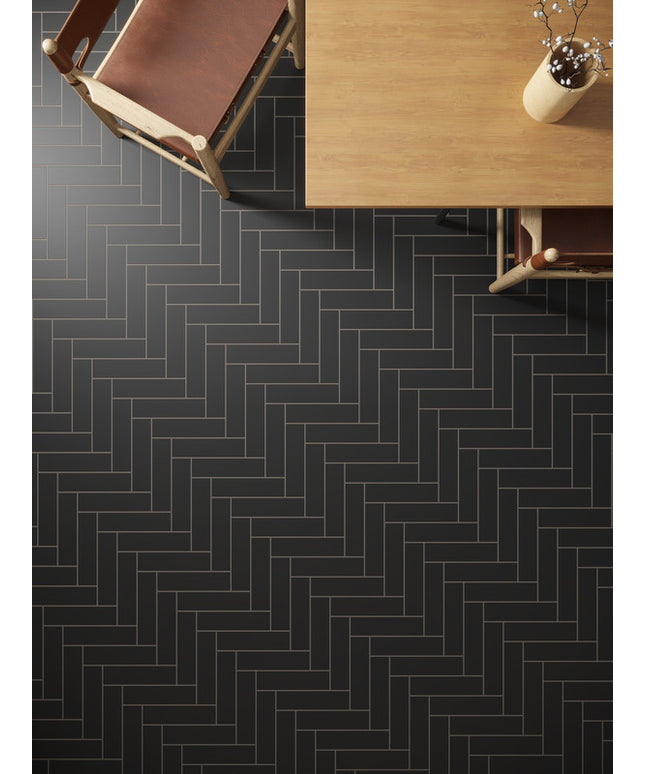 Modern dining room with black herringbone tile floor and wooden furniture