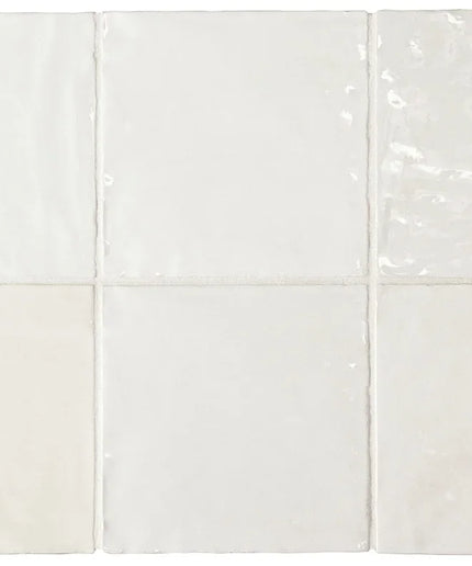White ceramic tiles with a subtle pattern on a white background