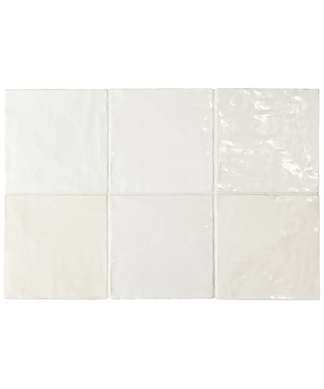 White ceramic tiles with a subtle pattern on a white background
