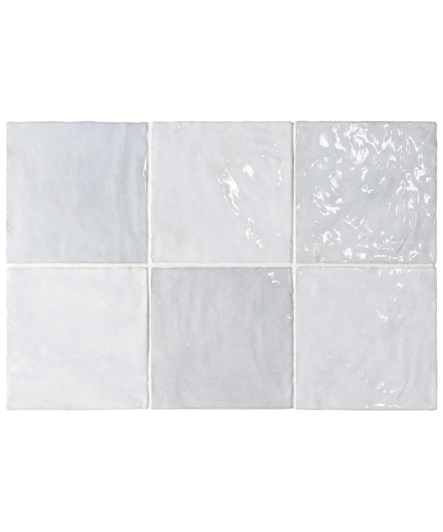 Set of six white ceramic tiles with subtle patterns on a white background