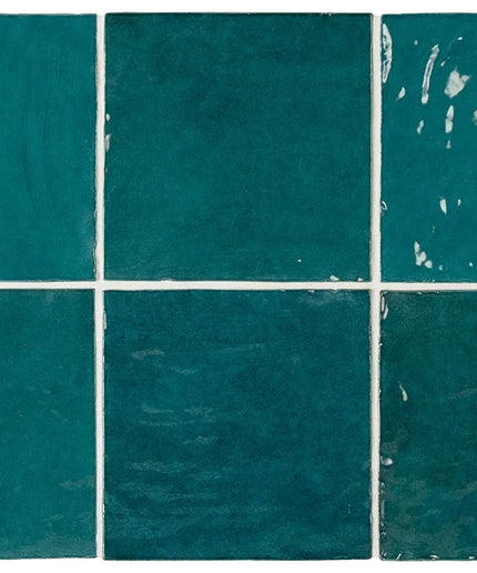 Teal tiles with visible wear and tear on a white background