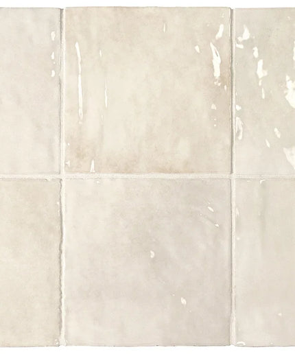 Set of six ceramic tiles in a beige color with subtle patterns