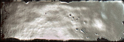 Close-up of a textured surface with small holes and a dark border.