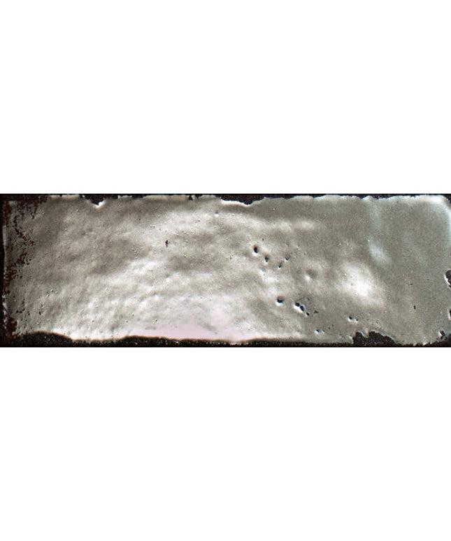 Close-up of a textured surface with small holes and a dark border.
