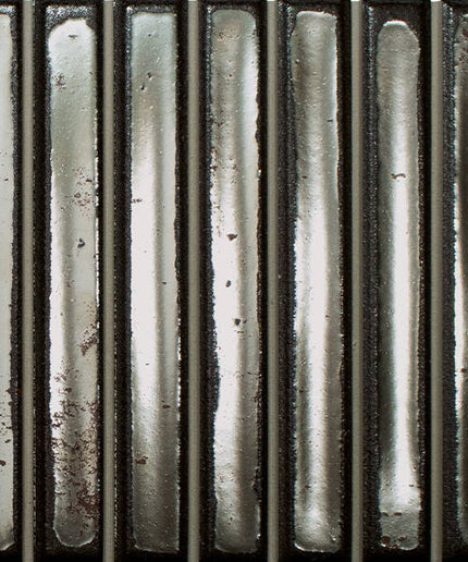Metallic cylindrical objects with a textured surface on a black background