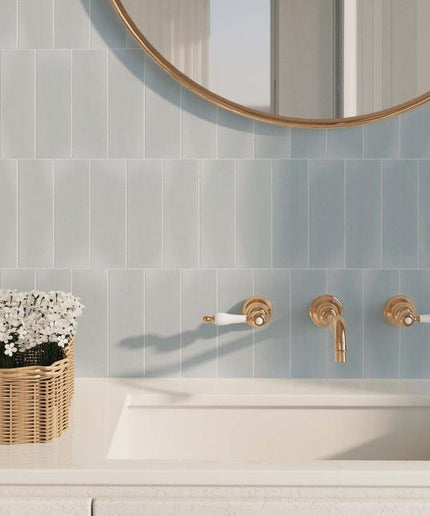 Bathroom with tiled wall, sink, and decorative elements