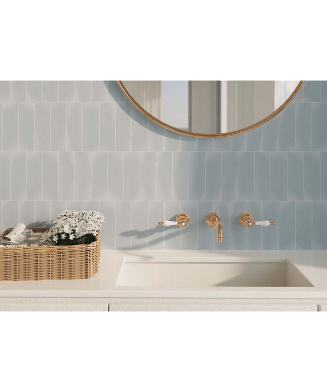 Bathroom with tiled wall, sink, and decorative elements