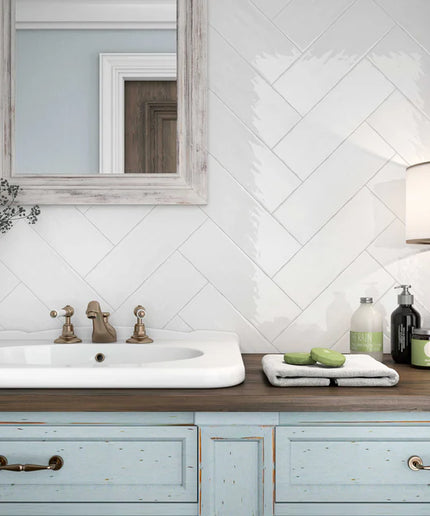 White herringbone tile bathroom backsplash with rustic vanity and modern decor