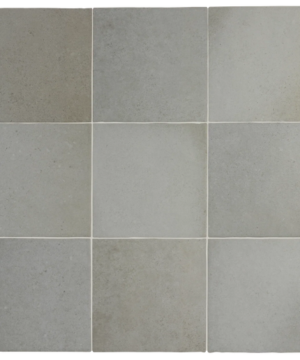 A 3x3 grid of square tiles in light gray and warm greige tones, showing a textured stone or ceramic surface.