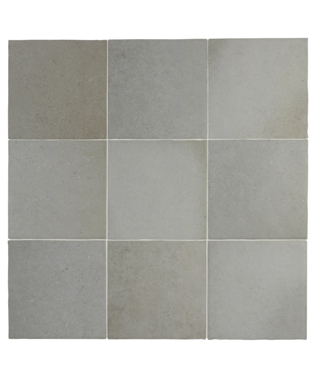 A 3x3 grid of square tiles in light gray and warm greige tones, showing a textured stone or ceramic surface.