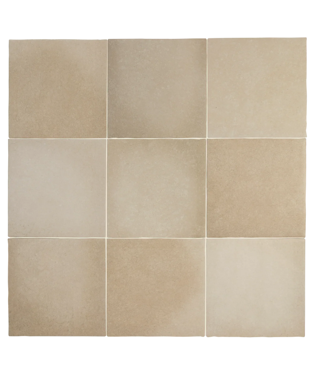 A 3x3 grid of square beige stone-look tiles with subtle natural tonal variation and light grout lines.