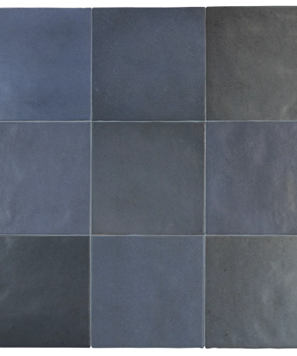 A 3x3 grid of square ceramic tiles in various shades of slate blue, navy, and charcoal gray, arranged in a clean pattern with thin grout lines.