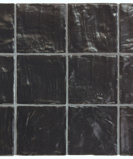 Black square tiles with a glossy finish on a white background
