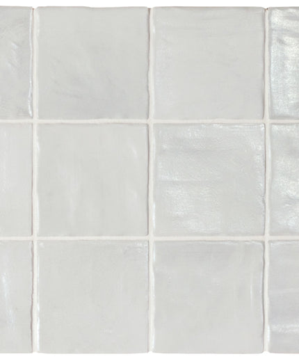 White ceramic tiles with a subtle pattern on a white background