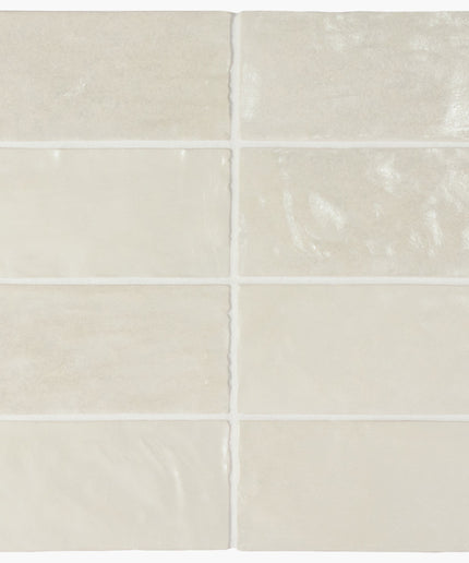 Set of six beige ceramic tiles with subtle patterns on a white background