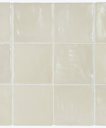 Beige ceramic tiles arranged in a grid pattern on a white background