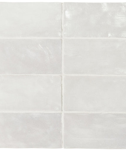 Set of four white ceramic tiles with a subtle pattern on a white background