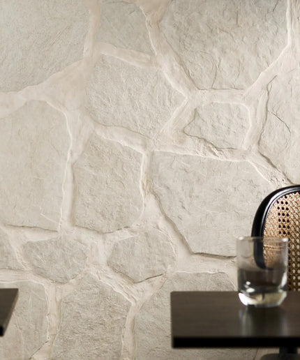 Decorative stone wall with a glass of water on a table
