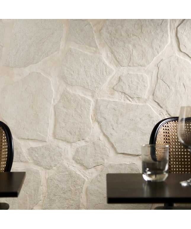 Decorative stone wall with a glass of water on a table
