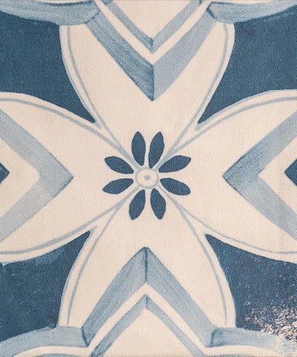 Blue and white patterned ceramic tile with floral and geometric design for floor or backsplash