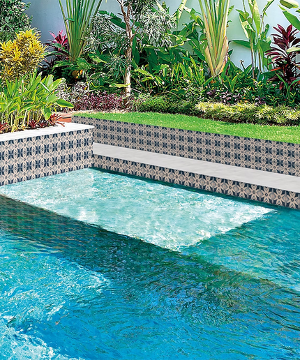 Patterned pool tiles with geometric design in a modern backyard oasis