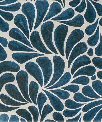 Blue and white ceramic tile with abstract petal pattern, decorative floor or wall tile.