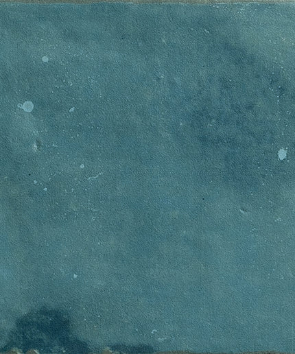 Square turquoise ceramic tile with a textured, slightly distressed matte finish.