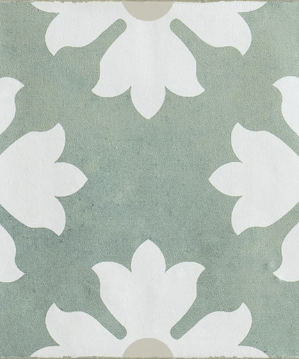 Green and white patterned ceramic tile with floral motif, ideal for floor or backsplash use