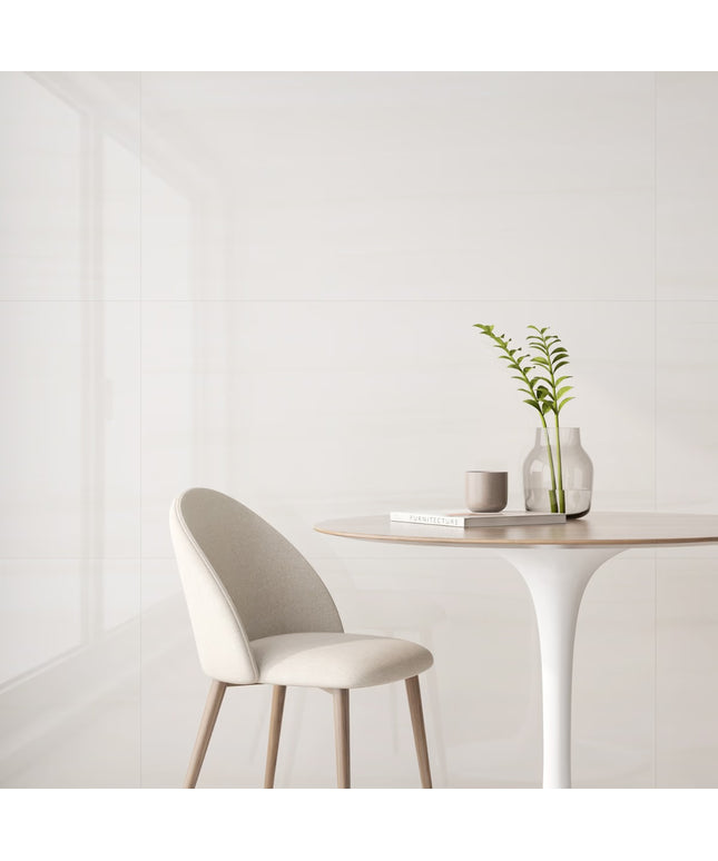 Modern chair and table setup with a plant and books on a white background