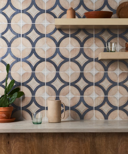 Kitchen with patterned tiles on the wall and wooden shelves.