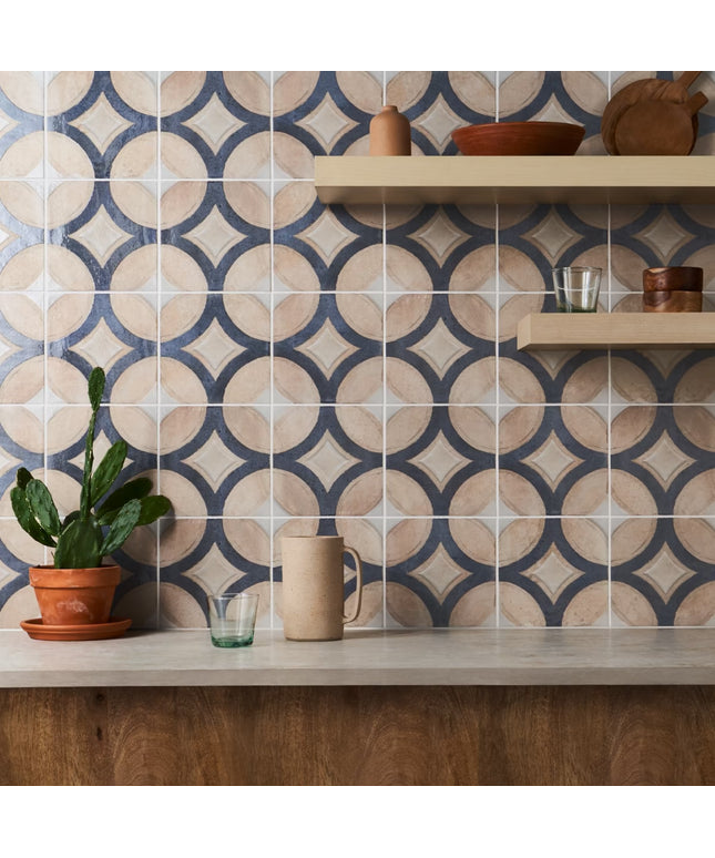 Kitchen with patterned tiles on the wall and wooden shelves.