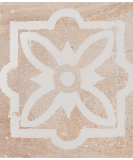 Decorative tile with a white floral design on a beige background
