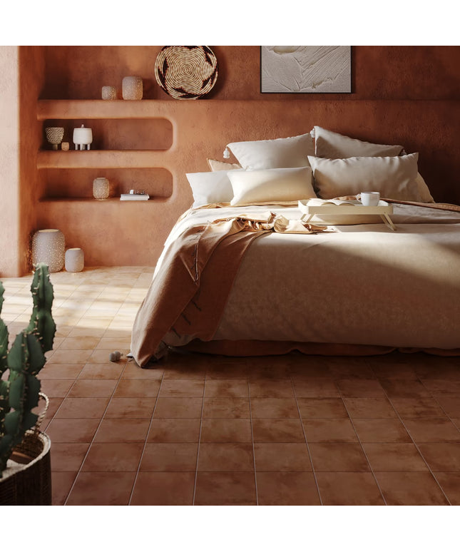 Bedroom with terracotta walls, bed, and shelves with decorative items.