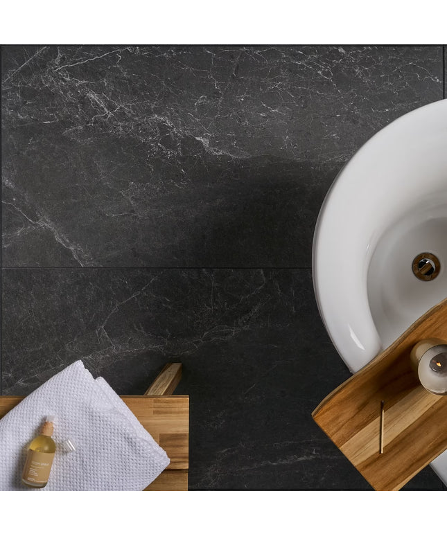 Bathroom setting with a white sink on a dark marble countertop