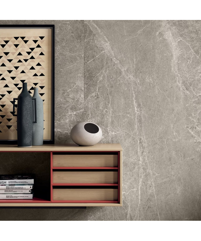 Modern interior design with a sideboard, decorative items, and a framed artwork against a gray marble wall.