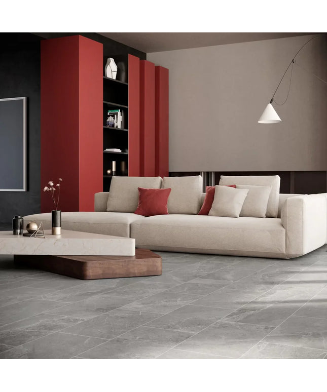 Modern living room with a beige sofa, red cushions, and a red bookshelf.
