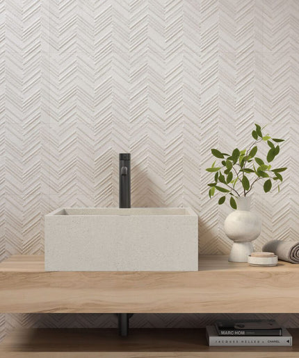 Ivory herringbone ceramic tile bathroom wall with modern sink and wood vanity