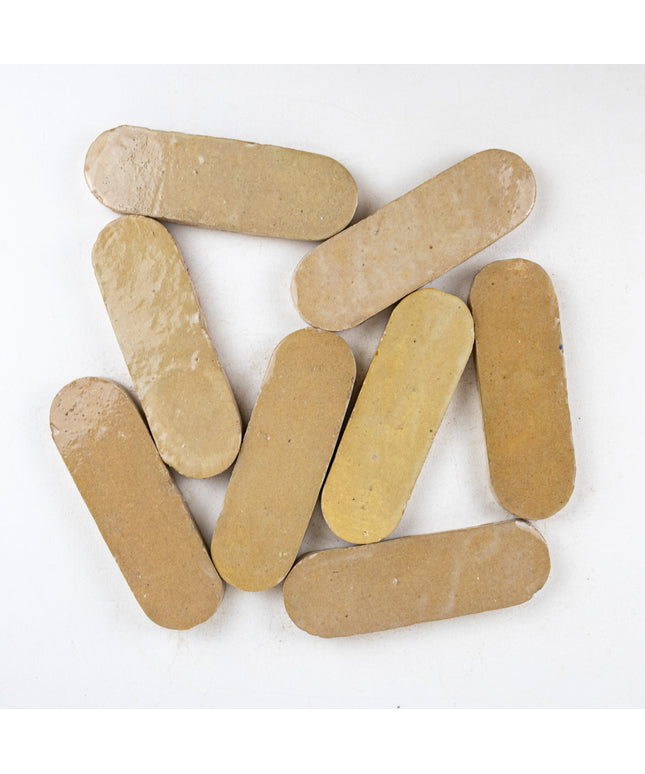 Sand-colored 2x6 oval ceramic tiles with glossy finish, ideal for backsplash or bathroom decor