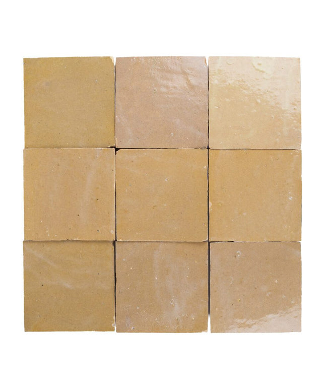 Square sand-colored zellige tiles with a glossy finish, ideal for kitchen backsplash or bathroom.