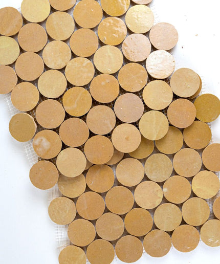 Beige round mosaic tile sheet with sand-colored ceramic circles for backsplash or floor.