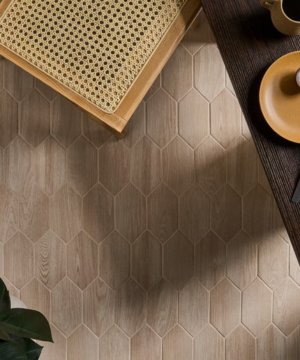 Hexagonal wooden tiles on a floor with a table and decor items.