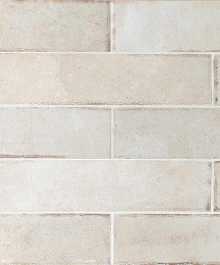 Beige tiles with a subtle pattern on a white background