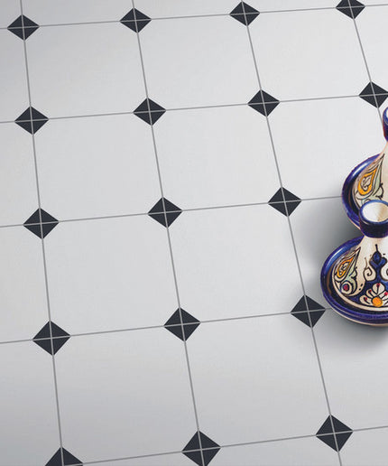 White octagon floor tiles with small black diamond dots, decorative vases on tile surface
