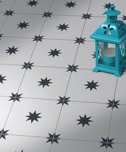 Patterned star floor tiles in black and white with decorative blue lanterns