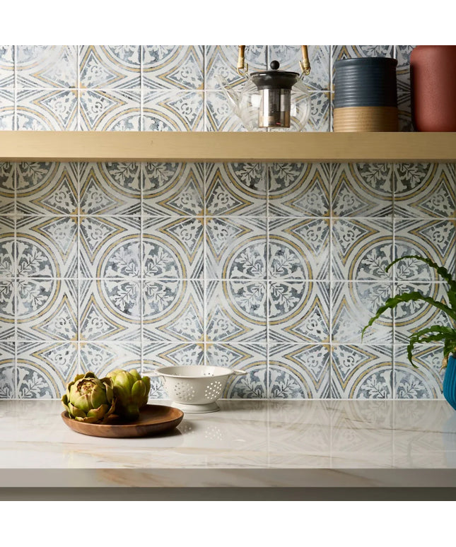 Decorative tile pattern on a kitchen wall with a shelf and plants.