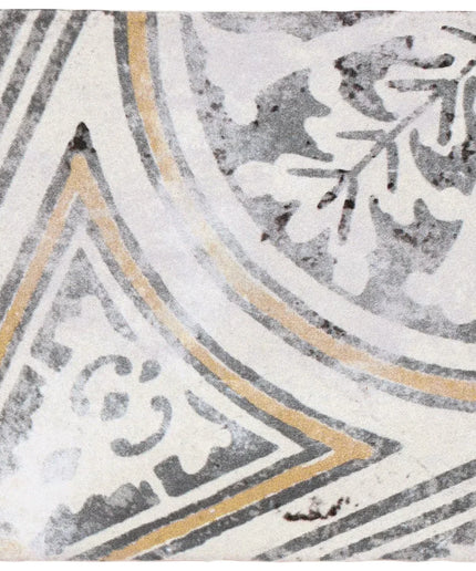 Decorative tile with geometric pattern in gray, white, and gold on a textured background
