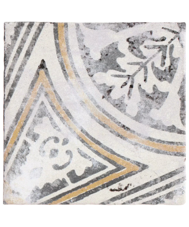 Decorative tile with geometric pattern in gray, white, and gold on a textured background