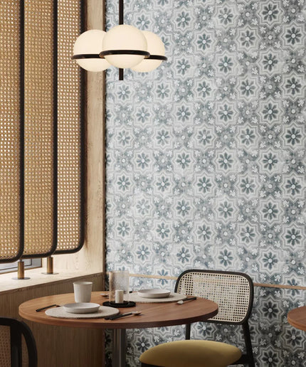 Dining area with patterned wallpaper, round table, and chairs.